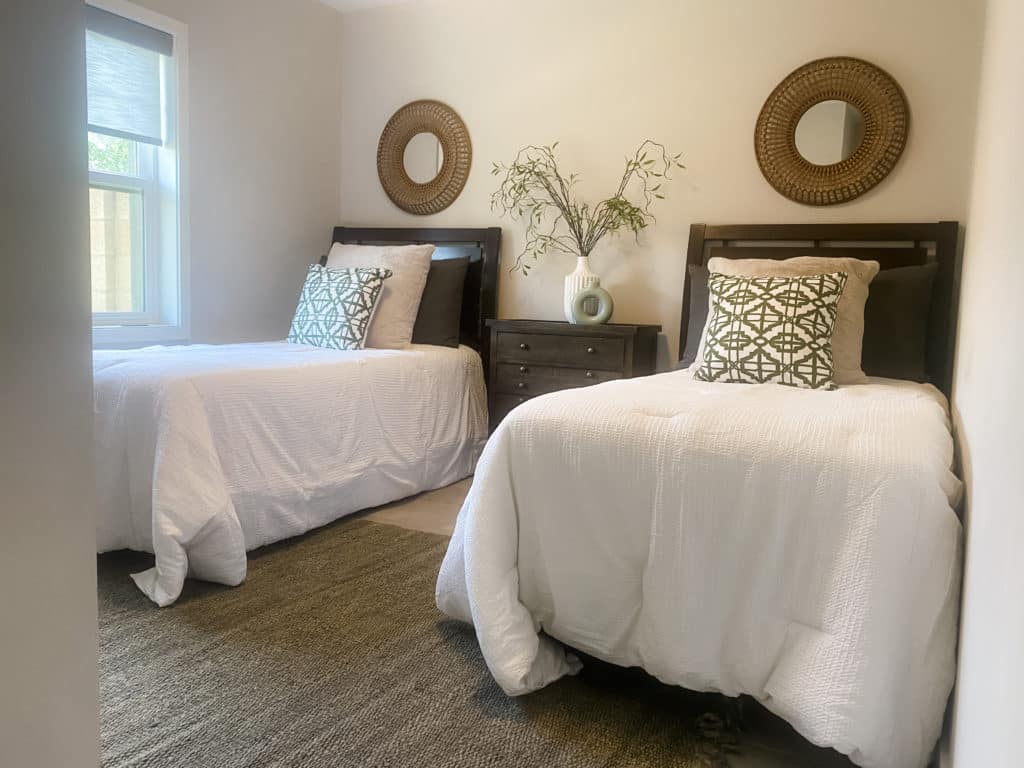 Small bedroom featuring two twin size beds and nightstand